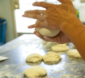 Shaping pizza dough.